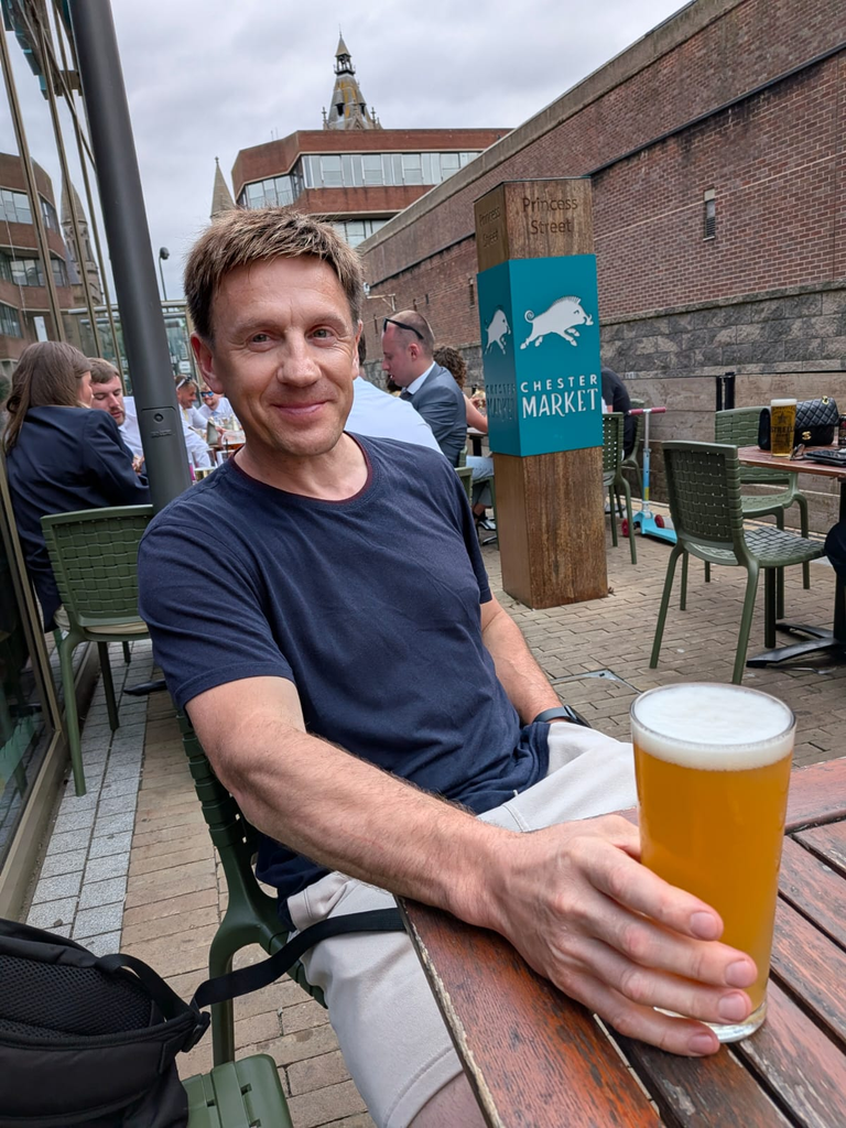 Pawel relaxing with a pint in CHester after a successful shodan grading.